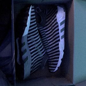 Grey and green EQT Supports with black strips